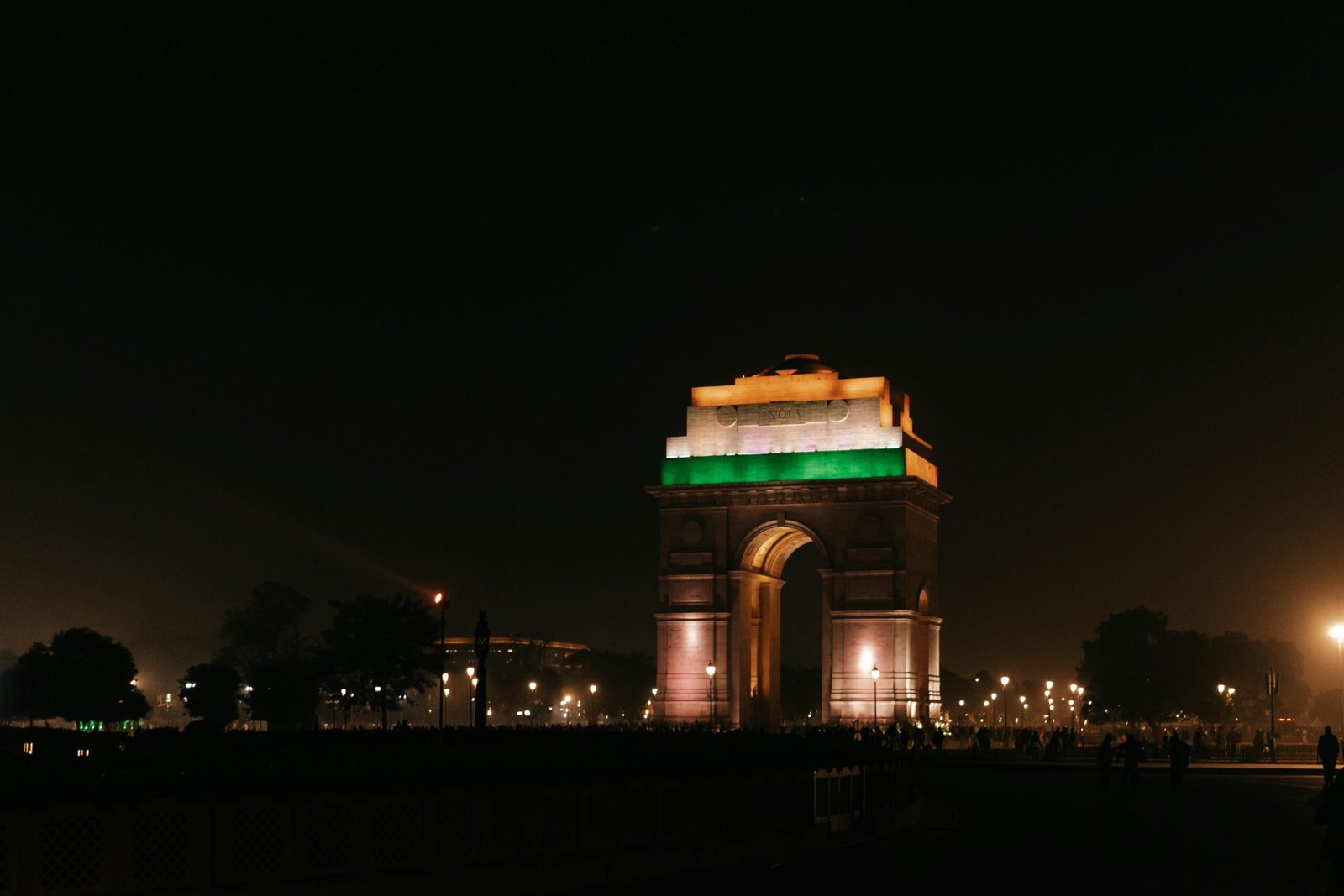 pexels-photo-19927019-19927019 India Gate, New Delhi, beautifully illuminated at night, showcasing vibrant colors and architectural beauty.