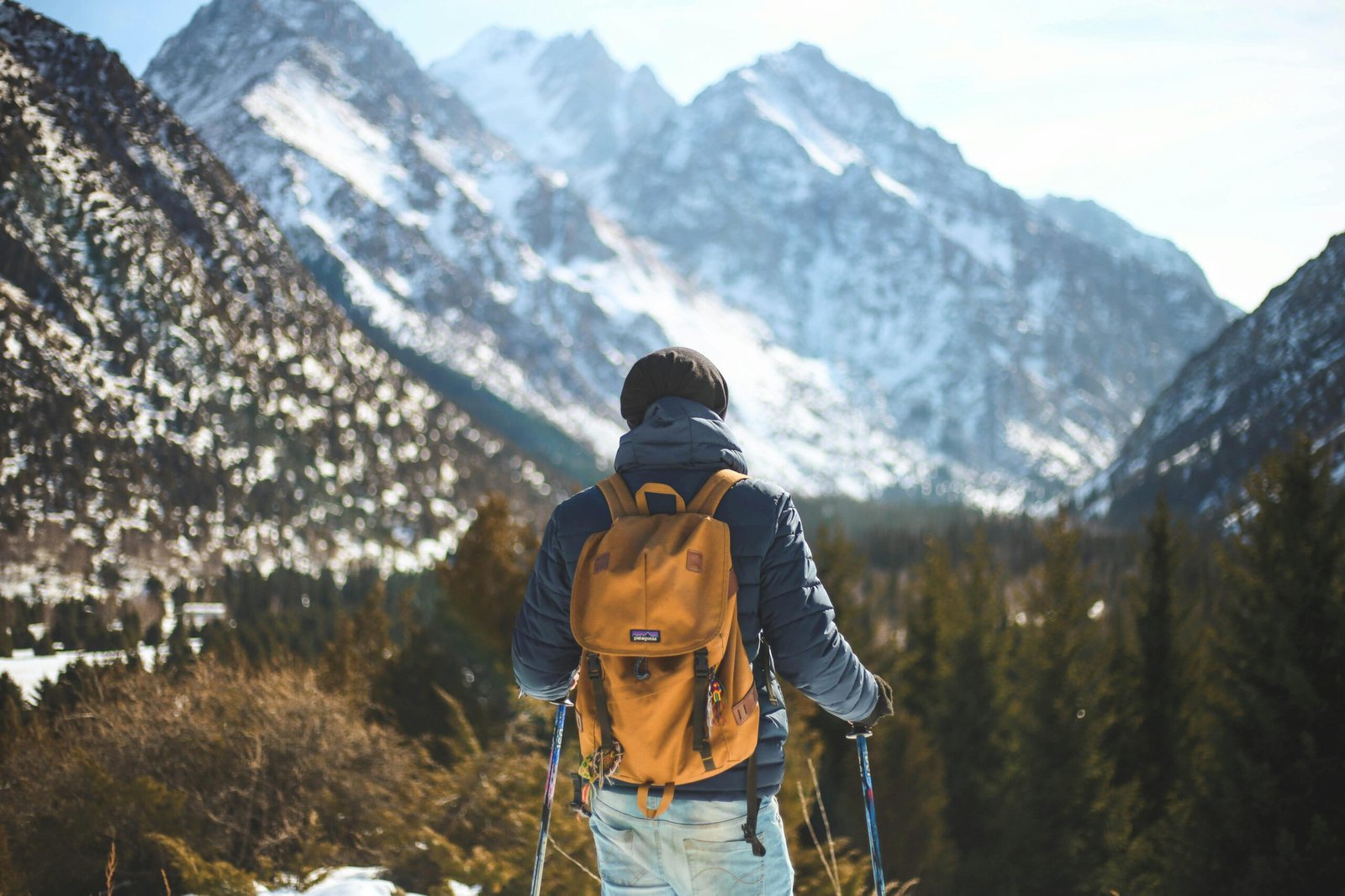 pexels-photo-868097-868097 A lone hiker with a backpack explores a scenic winter mountain landscape.